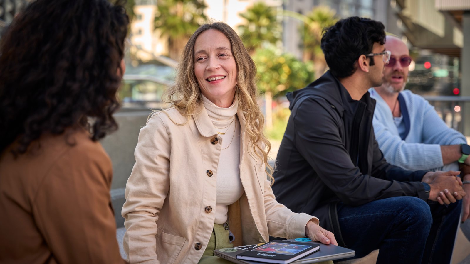 a person sitting on a bench with a group of people