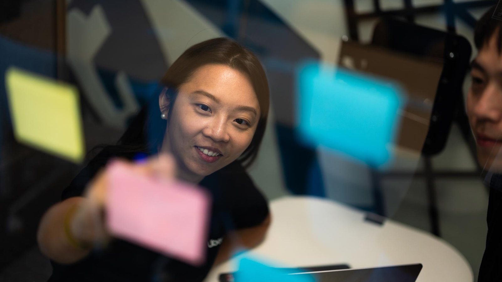 a person holding a post-it note