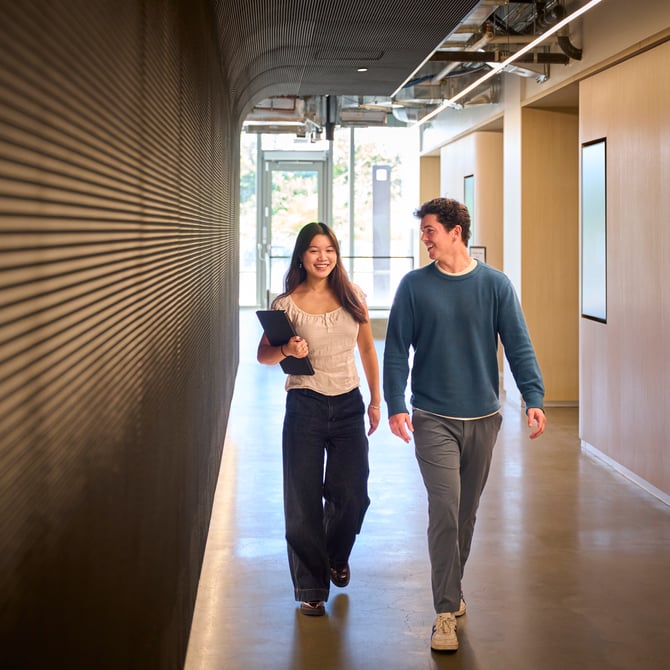 a person and person walking down a hallway