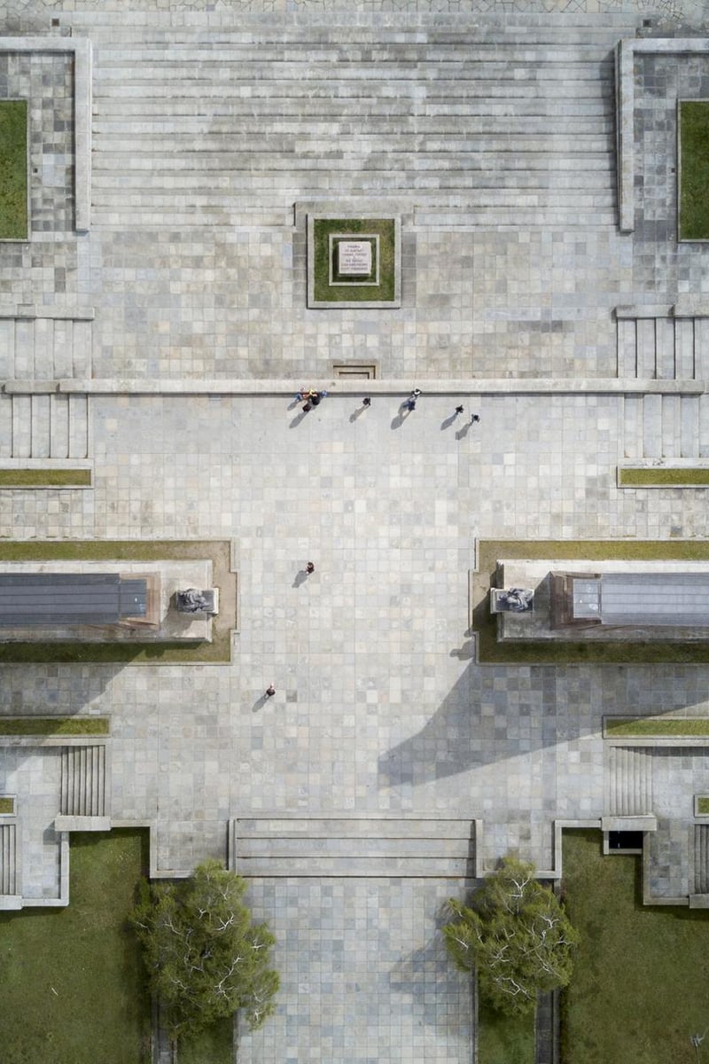a group of people walking in a courtyard