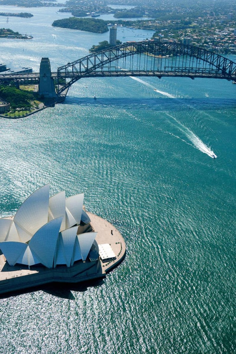 a bridge over water with a white structure