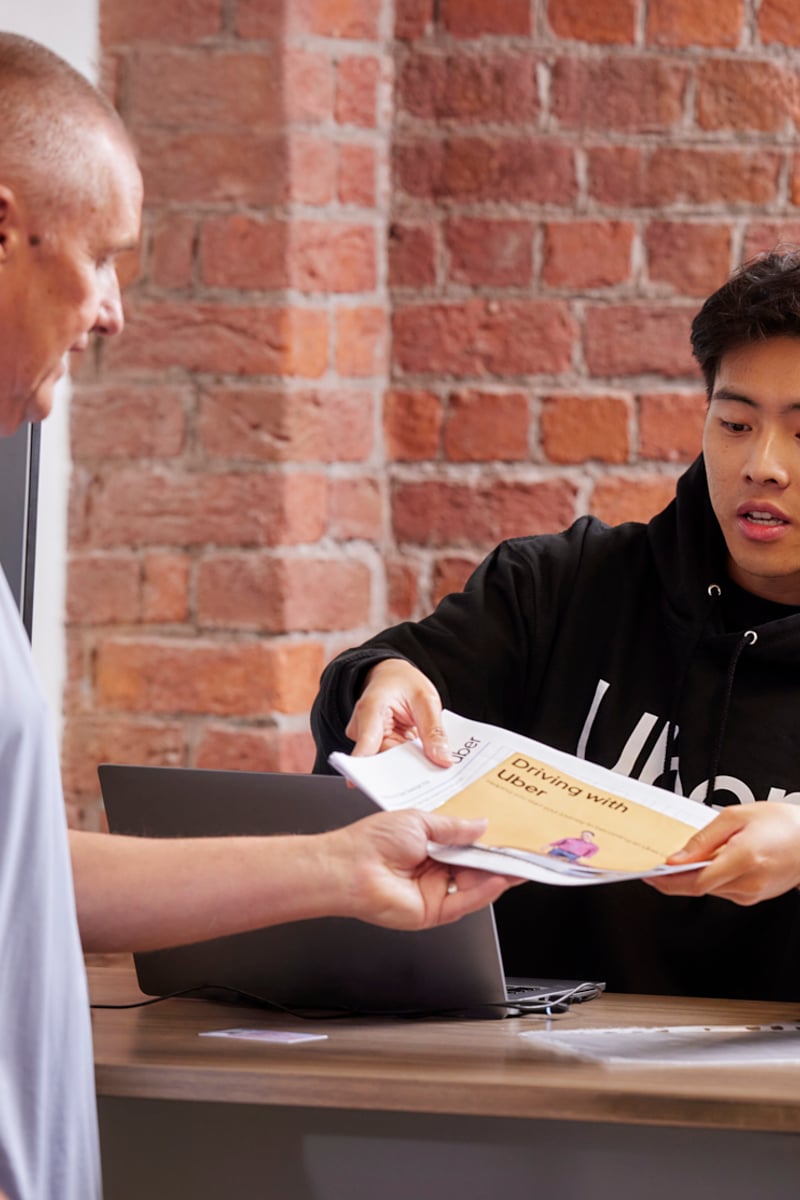 a person handing a paper to a person