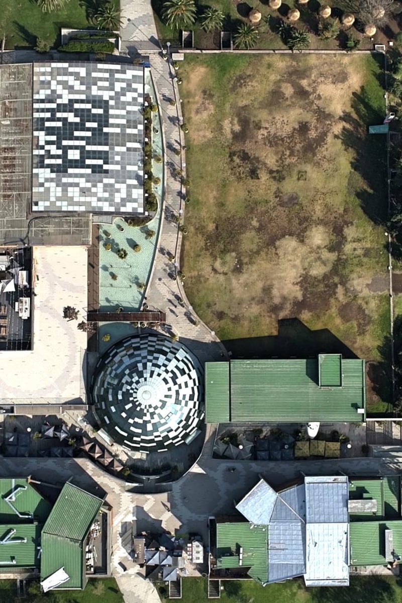 a building with a large dome and a pool