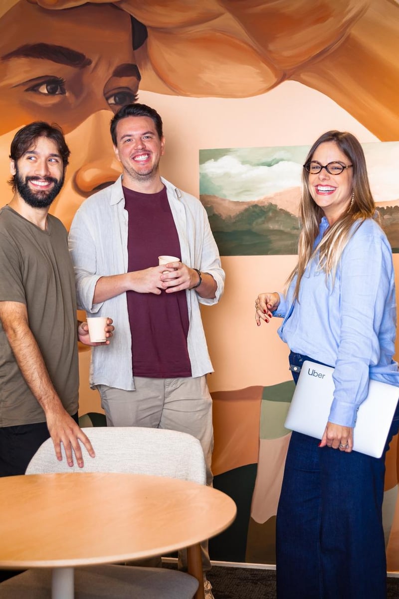 a group of people standing in a room with a mural of a person