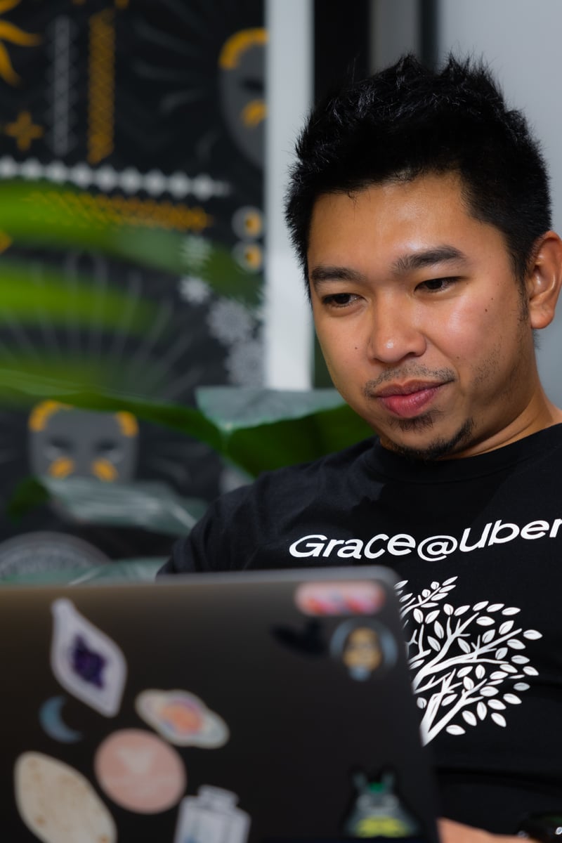 a person sitting in front of a laptop