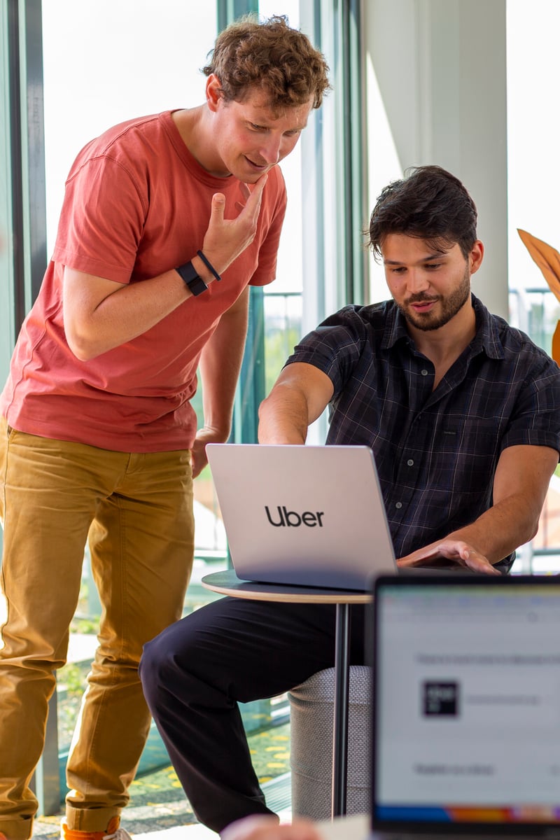 a group of people looking at a laptop