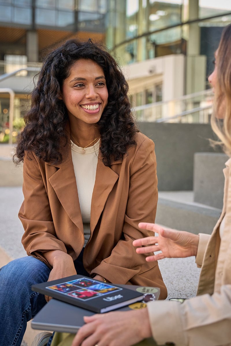a person sitting on a bench talking to another person