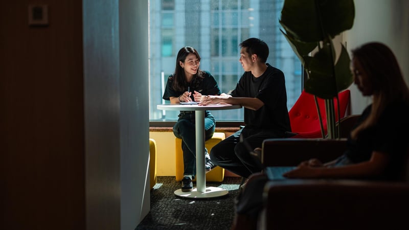 a person and person sitting at a table
