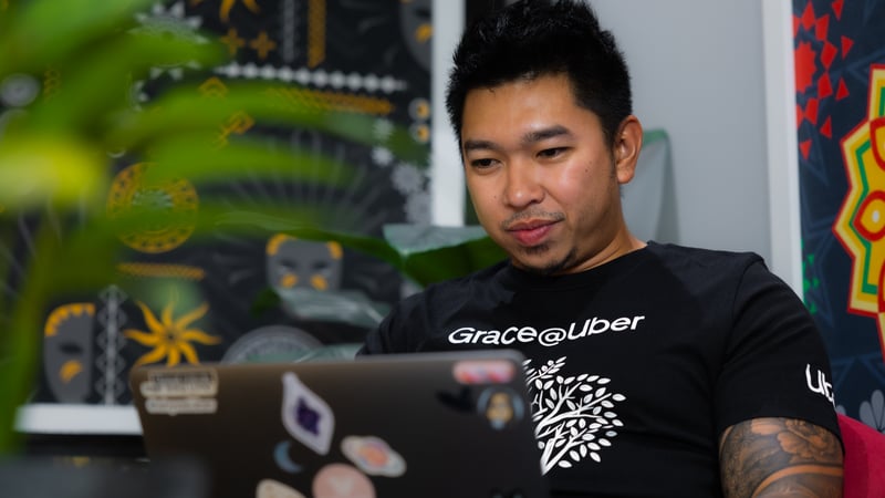 a person sitting in front of a laptop