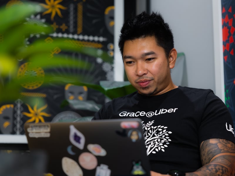 a person sitting in front of a laptop