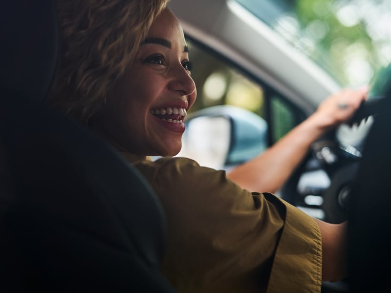 a person smiling in a car
