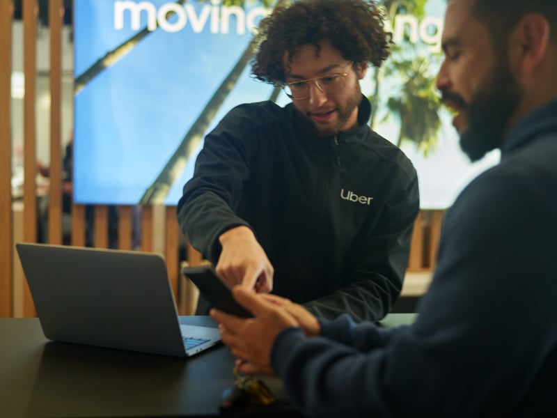 a person showing a phone to another person