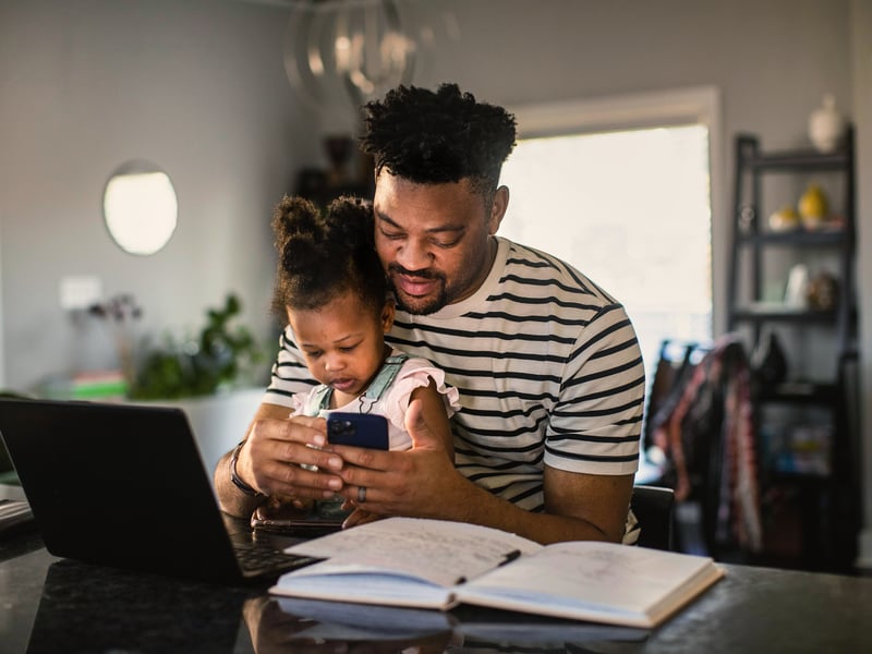a person and a child looking at a phone