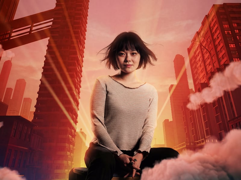 a person sitting on a chair in front of a city