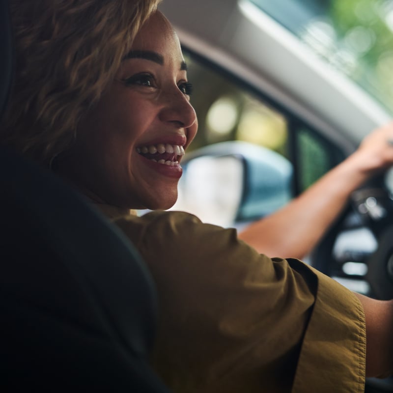 a person smiling in a car