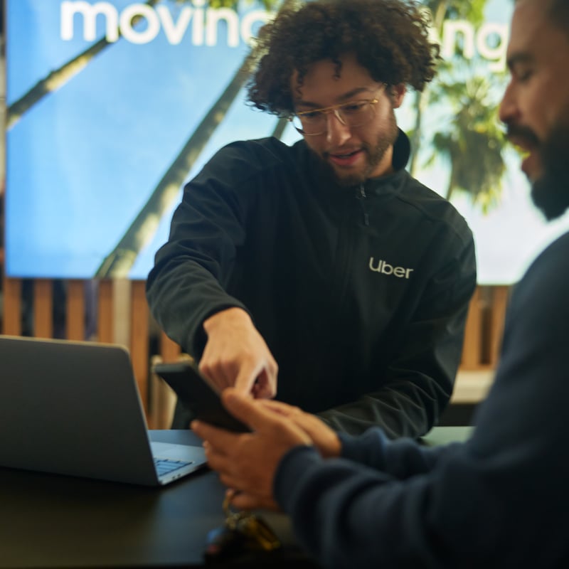 a person showing a phone to another person