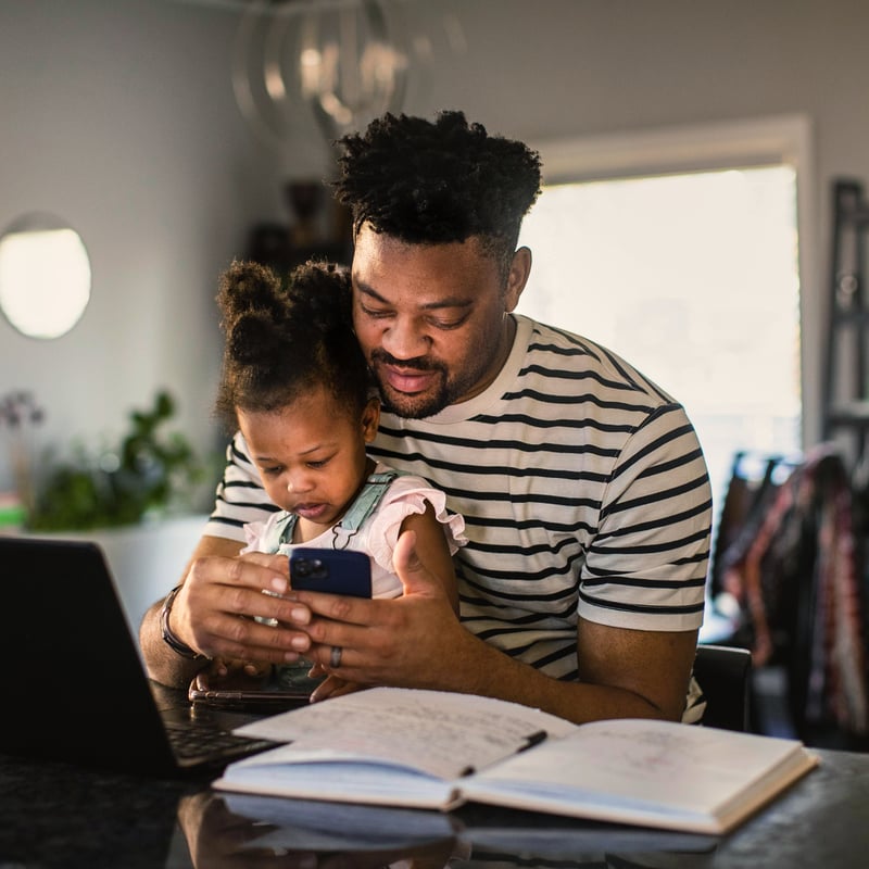 a person and a child looking at a phone