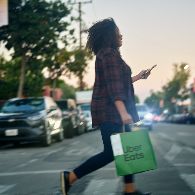 a person walking on the street with a bag