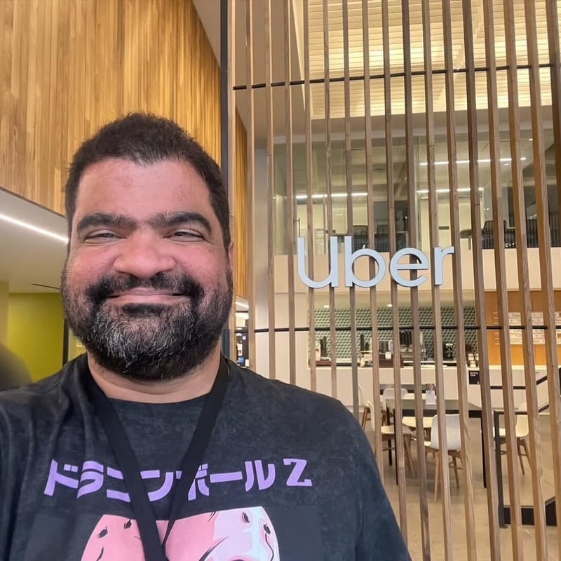 a person smiling in front of a glass wall