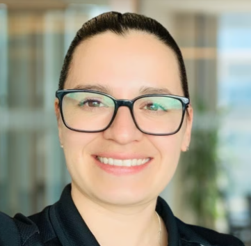 a person wearing glasses smiling