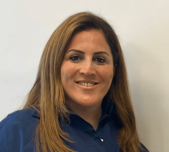 a person with long hair wearing a blue shirt