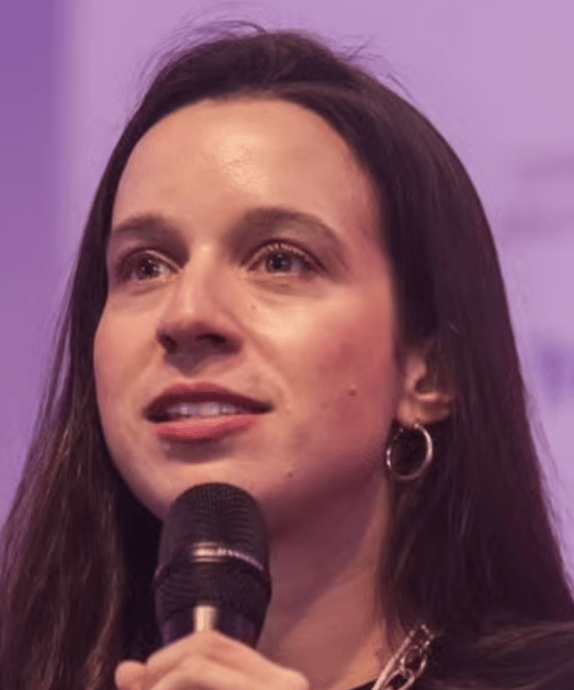 a person with long hair and a microphone