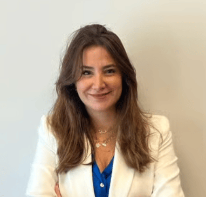 a person with long hair wearing a white jacket and blue shirt