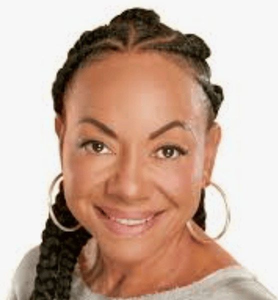 a person with braided hair smiling