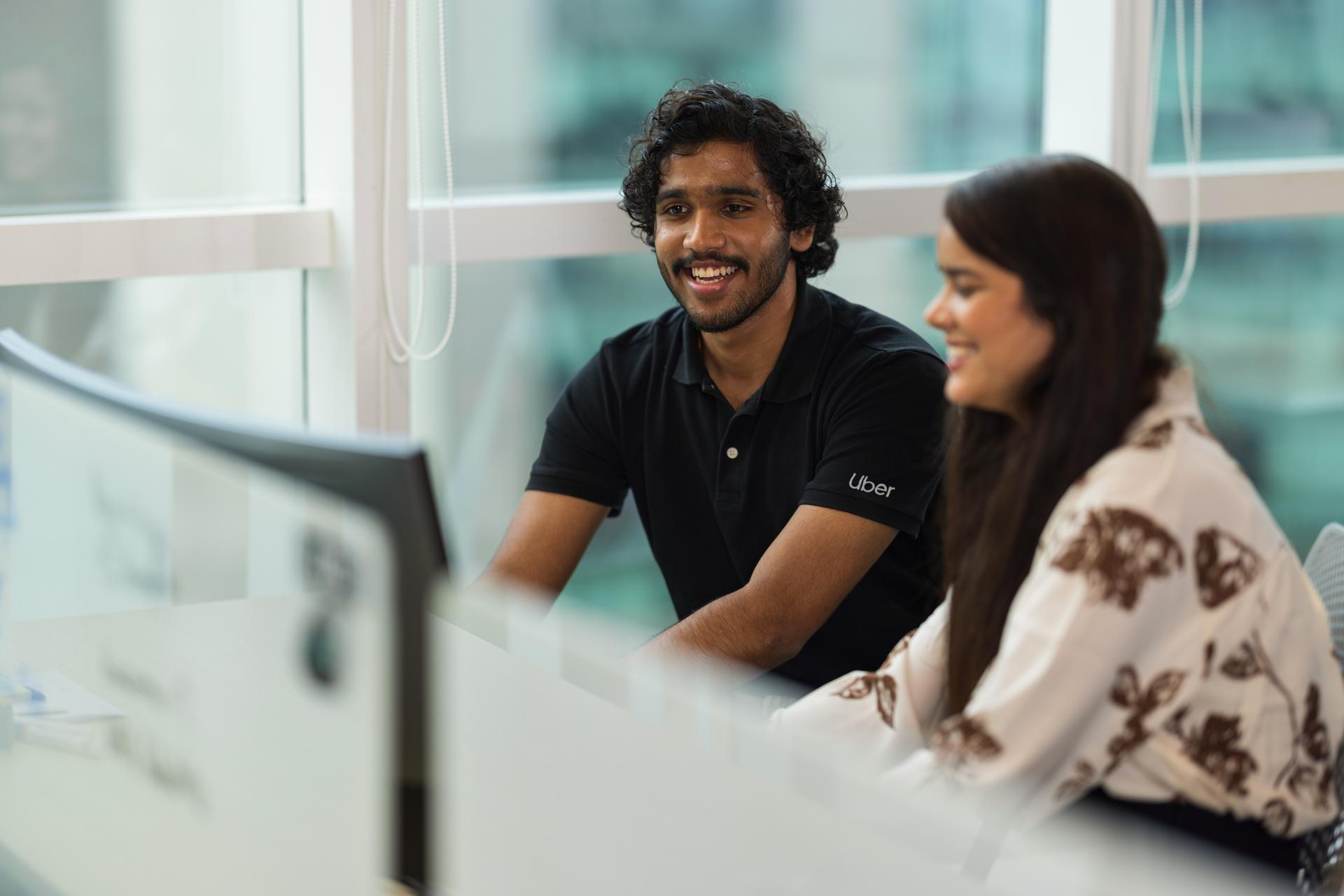 a person and person looking at a computer screen