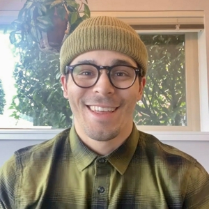 a person wearing glasses and a hat