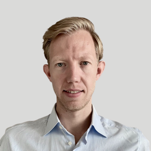 a person with blonde hair wearing a blue shirt