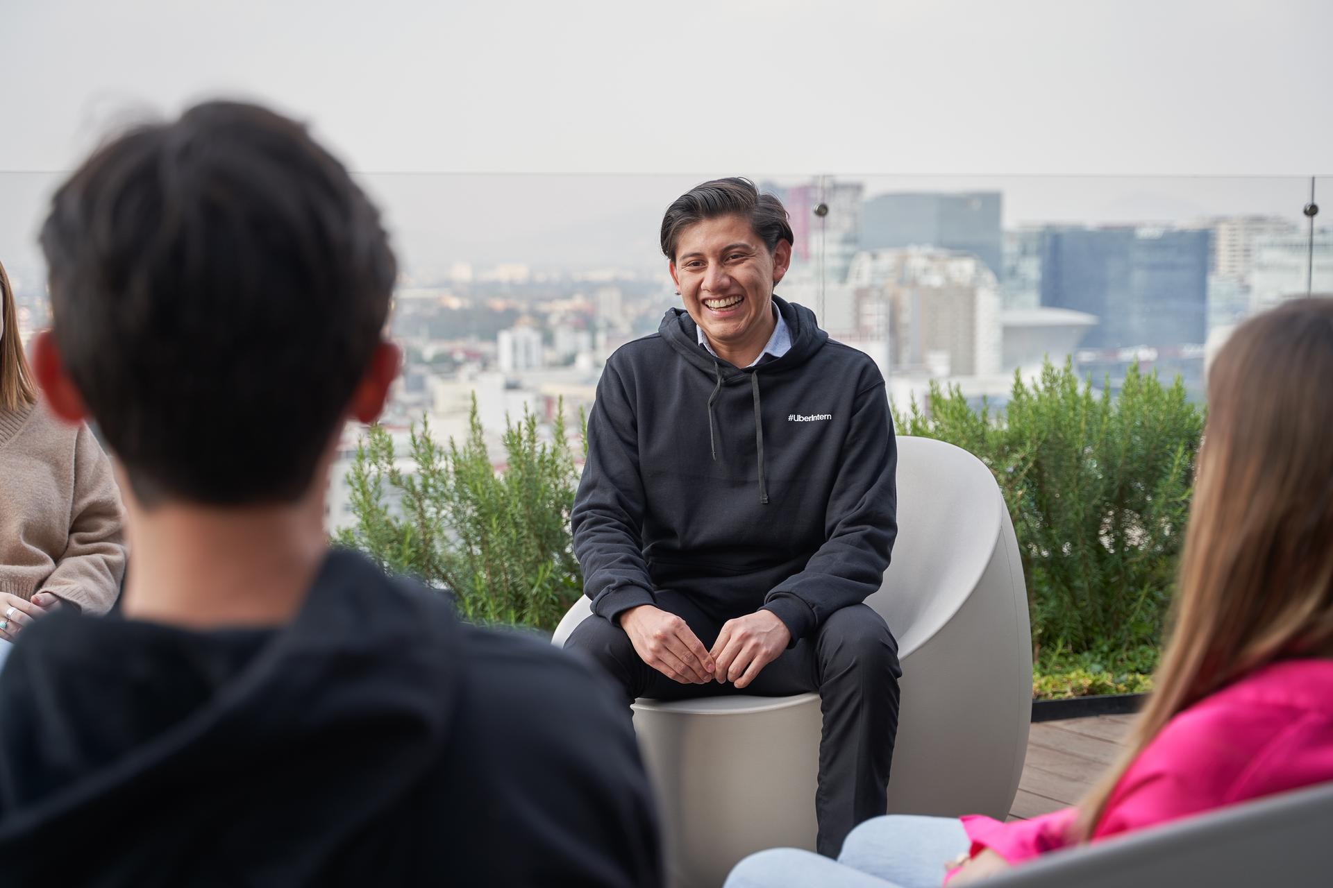 a person sitting in a chair with a city in the background