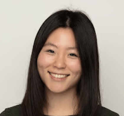a person with long hair smiling