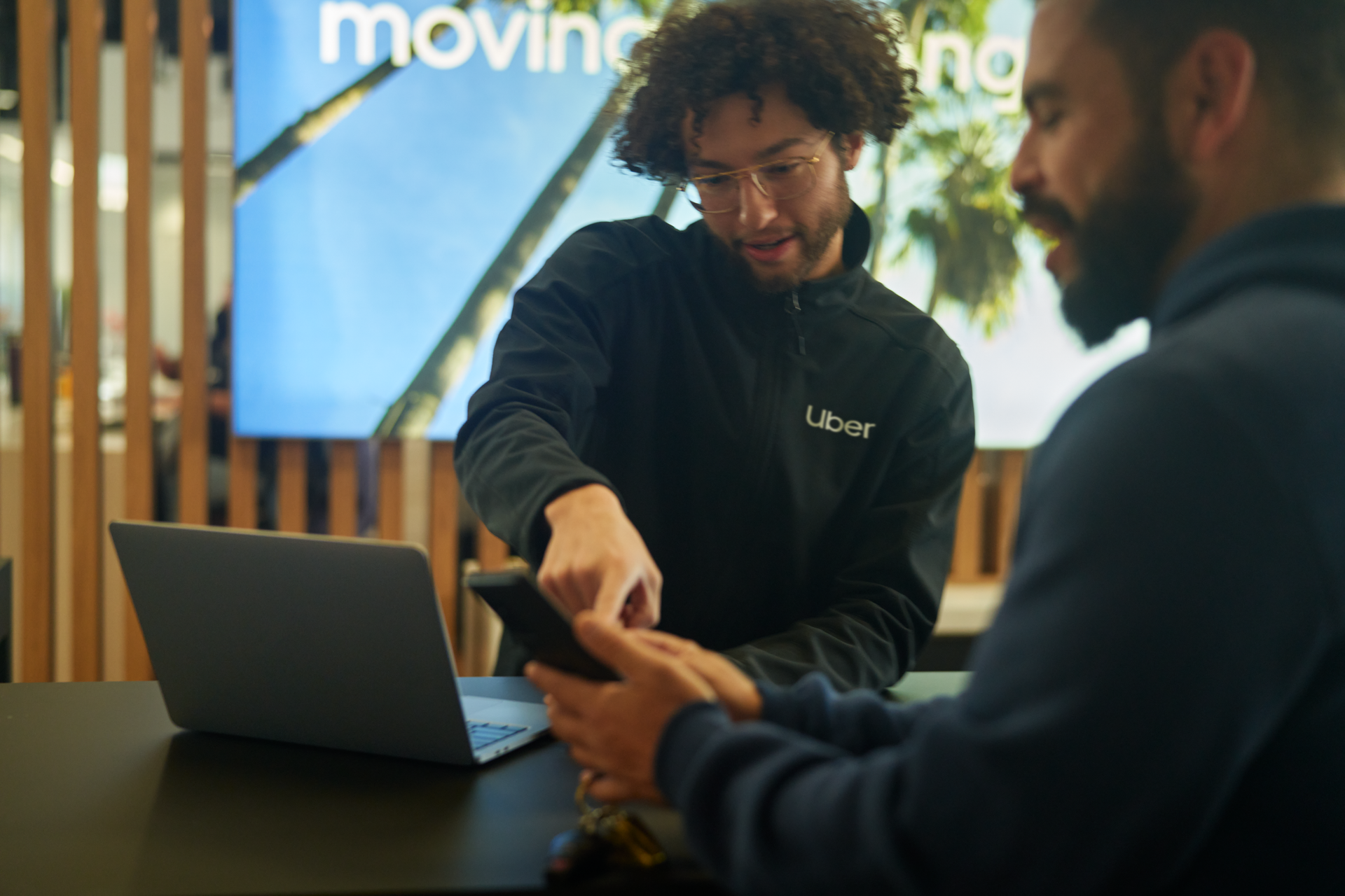 a person showing a phone to another person