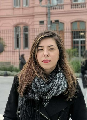 a person in a black coat and scarf