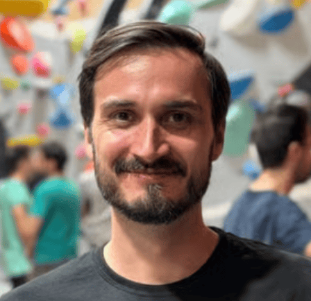 a person with a beard smiling