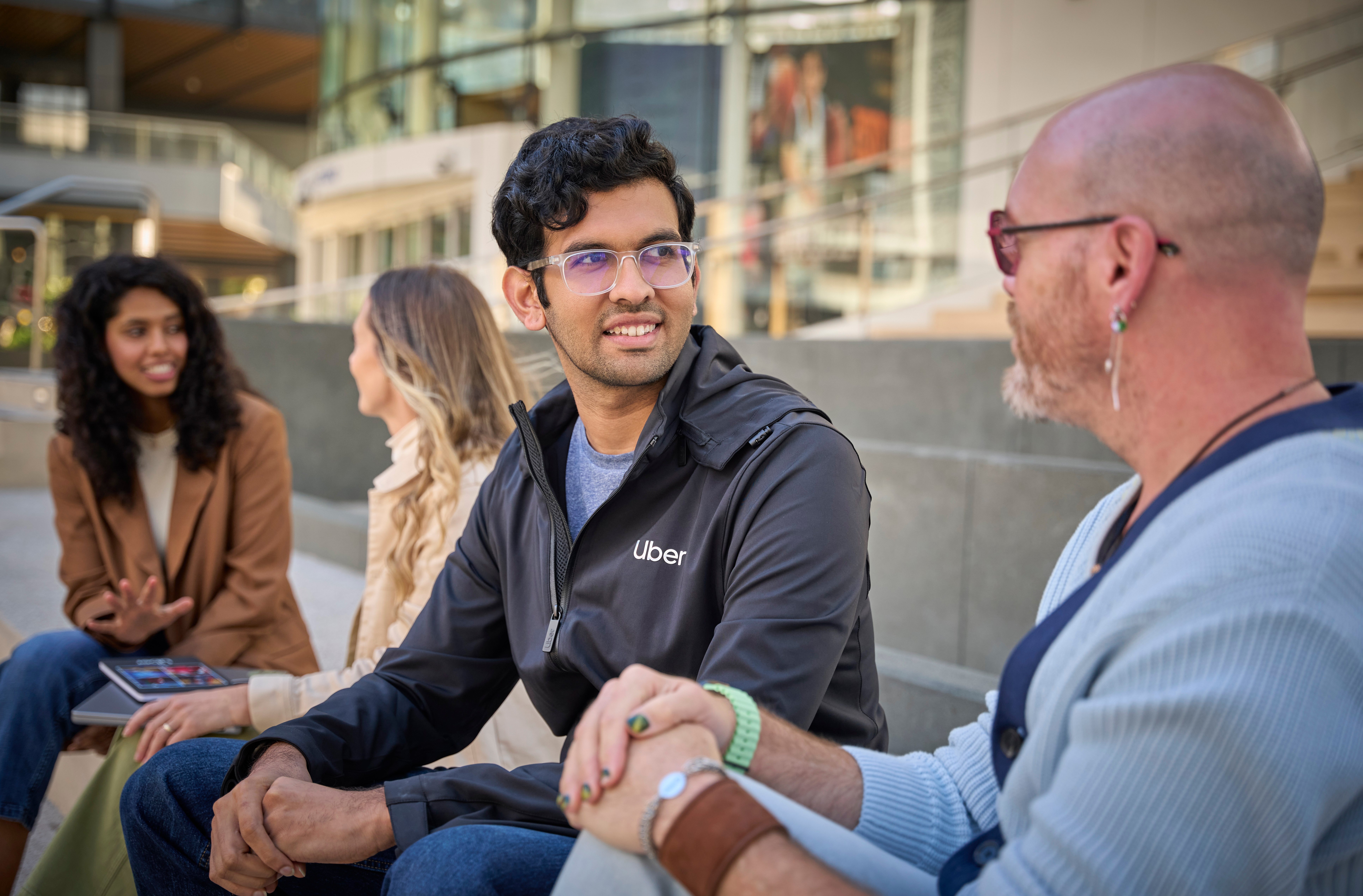 a person sitting on a bench with another person in glasses