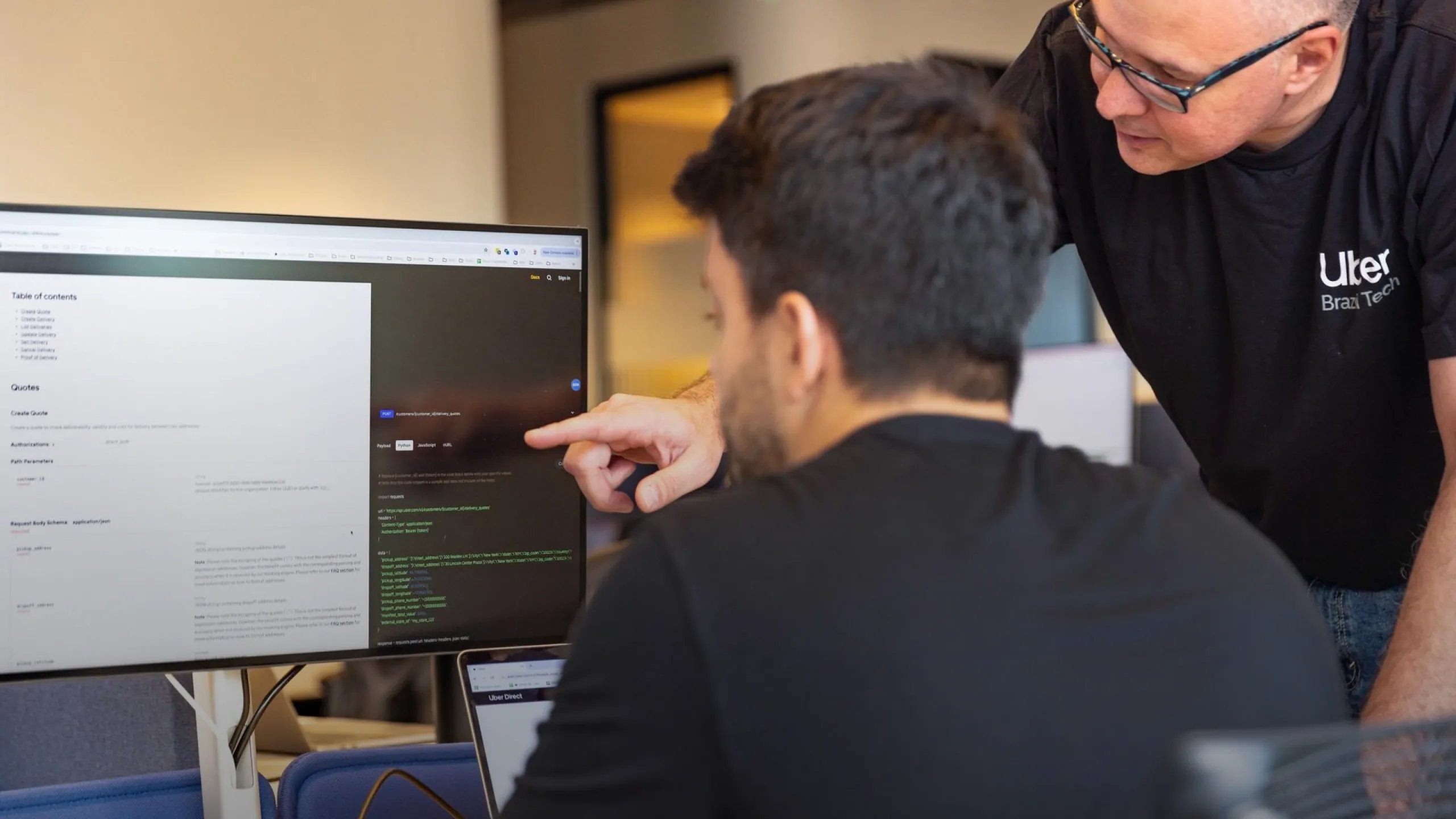 a person pointing at a computer screen