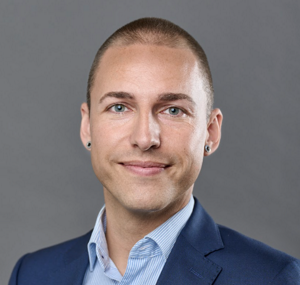 a person in a suit smiling