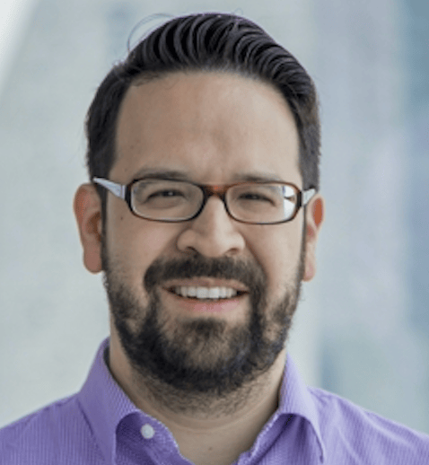 a person wearing glasses and a purple shirt